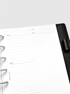 Close up of Mental Download inserts inside discbound planner and leather cover.