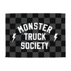 Checkered flag with 'Monster Truck Society' text and lightning bolts on a white background