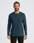 Man wearing Navy Classic Long Sleeve Henley and black pants, smiling.