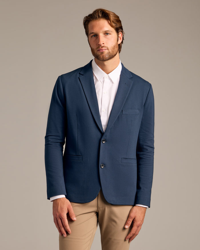 Navy Comfort Knit Blazer worn in a modern business-casual style.