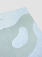 Close up of blue-green flocking on the organic shape design displaying a velvet-like texture.
