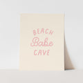 Beige poster with 'BEACH Babe CAVE' text in pink on a light gray background