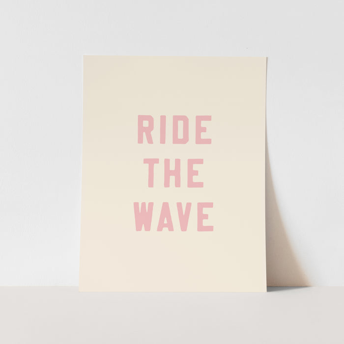Beige poster with 'RIDE THE WAVE' text in pink on a light gray background