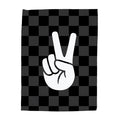 Black and white checkered towel with a peace sign design