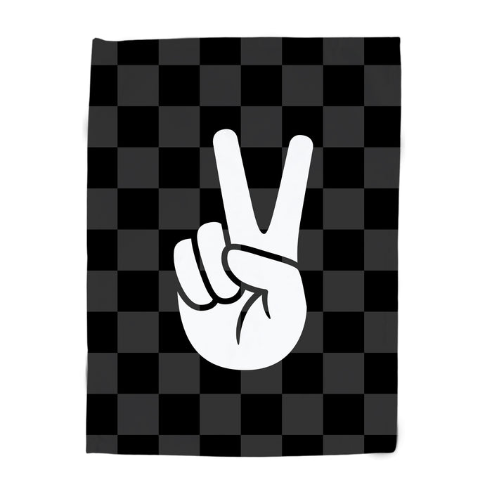 Black and white checkered towel with a peace sign design