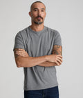 Model is wearing UNTUCKit Performance Tee in gray.