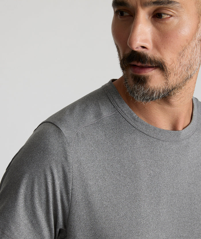 Model is wearing UNTUCKit Performance Tee in gray.