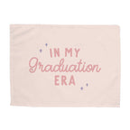 Pink blanket with 'In My Graduation Era' text on a white background