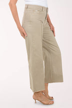 A woman wearing a flared brown crop pant.