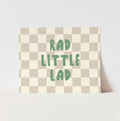 Checkered pillow with 'Rad Little Lad' text on a light gray background