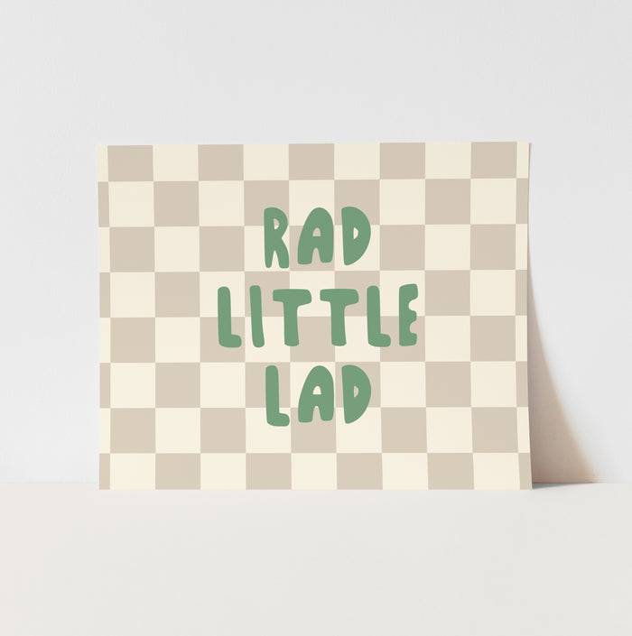 Checkered pillow with 'Rad Little Lad' text on a light gray background