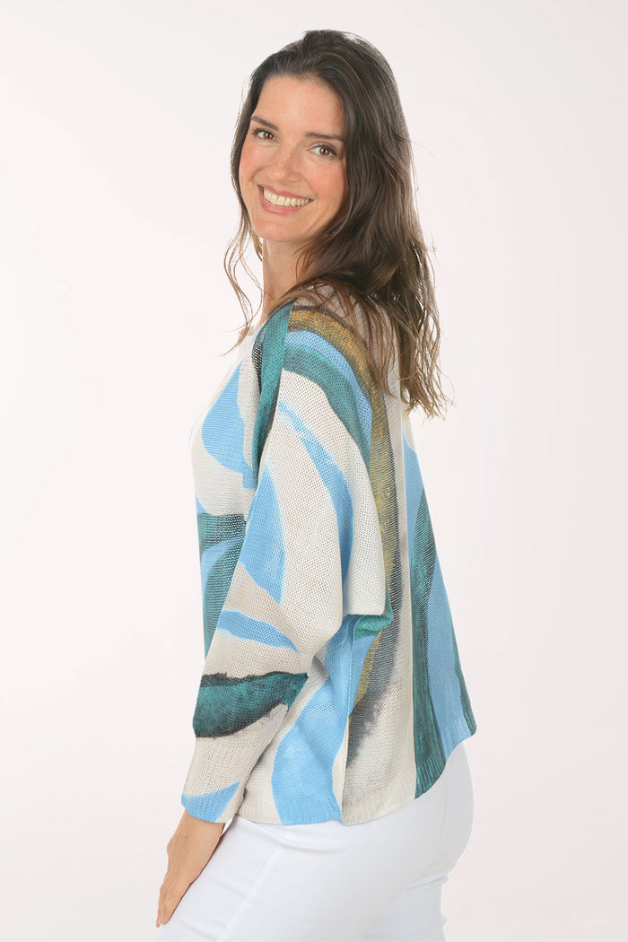 Woman wearing a slouchy blue sweater.