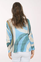 Woman wearing a slouchy blue sweater.