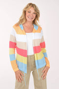 Woman wearing a colorful striped sweater on a white background