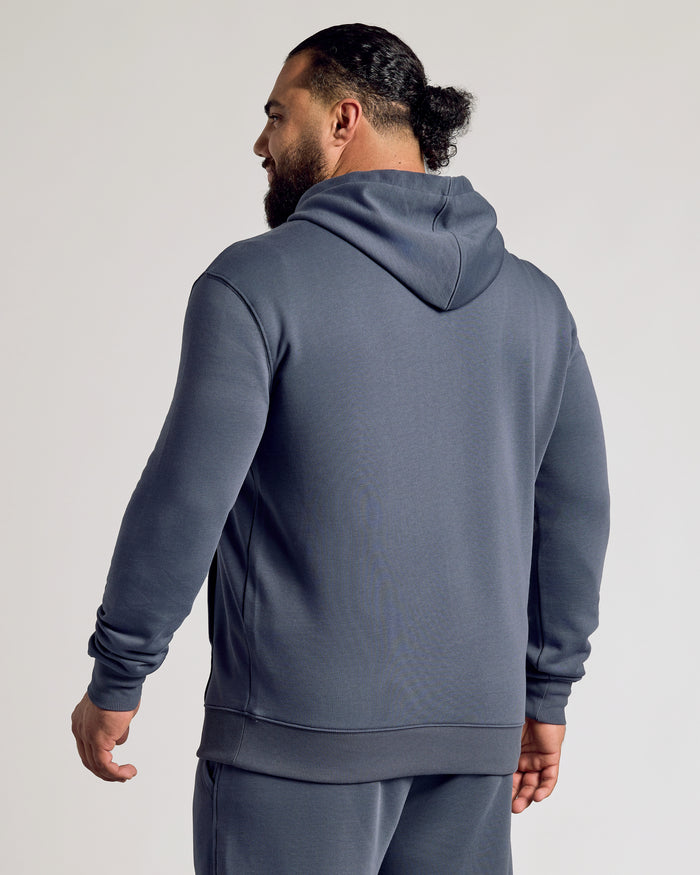 Man in Stormy Fleece French Terry Pullover Hoodie, hood down.