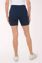 Person wearing navy blue shorts on a white background. Back shot