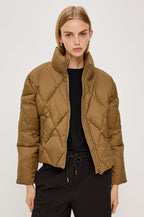 Summit Cropped Puffer Jacket With Stand Collar, Front Zipper, Quilted Detailing, Side Pockets, Tonal Branded Stamp, and Long Sleeves in Ginger Colorway - Upper Body Front View Featured on Model