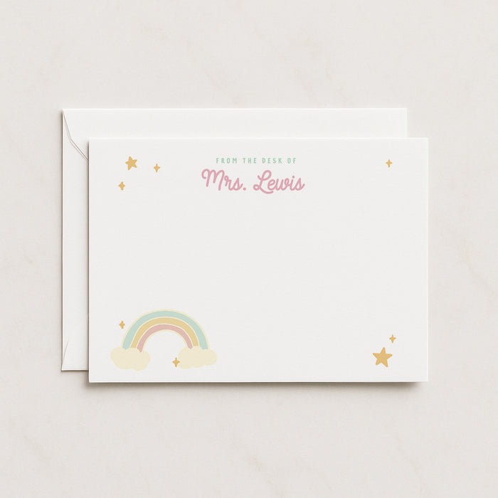 A stack of white flat note cards with a rainbow and stars design, and a personalized message that reads 'Mrs. Lewis'.