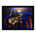 A poster featuring Steve Vai with a 3-necked guitar called, "The Hydra" in a setting with arches and a spotlight, predominantly black and blue.