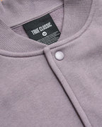 Thistle Fleece Bomber Jacket with snap-front, rib texture, and TRUE CLASSIC label.