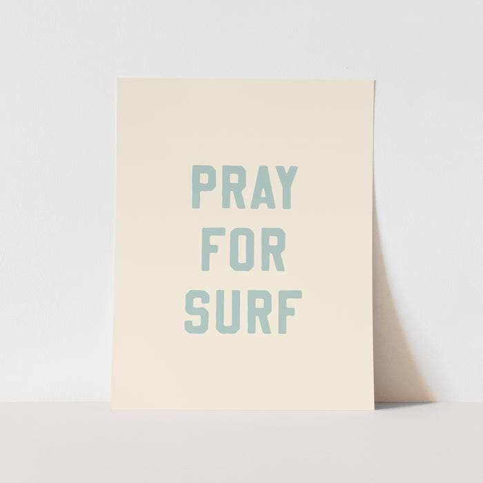 Beige poster with 'PRAY FOR SURF' text on a light gray background