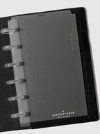 Black foil divider displayed in a black leather planner.