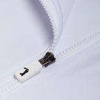 Close-up of the White - Q-Zip’s white zipper against a white fabric. The pull shows a small black icon. The fabric provides UPF 50 sun protection and moisture wicking, while the partially open zipper reveals its textured teeth.