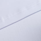 Close-up of White - Q-Zip’s moisture-wicking fabric with a visible diagonal seam. The smooth, slightly textured material and precise stitching highlight the technical details and athletic fit of this performance piece.