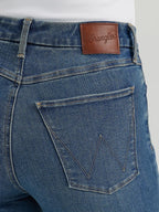 Close-up of blue jeans with a Wrangler leather patch.